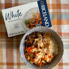 Riceland White Rice package with a bowl of rice and vegetables on a checkered tablecloth